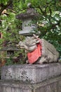 The statue of ox lying down near the stone lantern at Kitano Tenmangu shrine. Kyoto. Japan Royalty Free Stock Photo