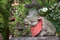 The statue of ox lying down near the stone lantern at Kitano Tenmangu shrine. Kyoto. Japan Royalty Free Stock Photo