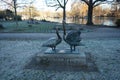 Statue of a pair of swans in a park in winter. 12555 Berlin, Germany