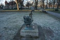 Statue of a pair of swans in a park in winter. 12555 Berlin, Germany