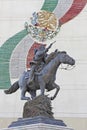 Statue of Pancho Villa on horseback pointing gun.