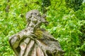 statue on a pedestal of a saint of a monastery in the forest detail