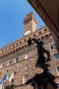 Statue of Perseus beheading the Medusa by Benvenuto Cellini at the Loggioa dei Lanzi in Florence, Palazzo Vecchio in the back Royalty Free Stock Photo