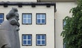 statue of a person in front of windows, Bergen, Norway