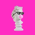 Statue on a pink background. Gypsum statue of Apollo head. Man. Creative. Plaster statue of Apollo head in pixel glasses. Minimal