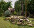 Statue in a place with lots of vegetation, located in a theme park.