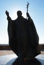 Statue of pope John Paul II with raised right hand and his cross in left hand, as installed on castle Nitra, Slovakia. Royalty Free Stock Photo