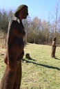 Statue of the pregnant woman standing on the grass field