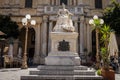 A statue of Queen Victoria in front of the National Library of Malta in Republic Square, Valletta, Malta.