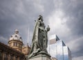 Statue of queen Victoria in Victoria Square, Birmingham England UK. Town hall behind and bronze statue on stone plinth Royalty Free Stock Photo