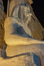 Statue and of Ramses II at entrance to Luxor Temple during night Royalty Free Stock Photo