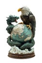 Bald eagle and dragon fighting over planet earth globe statue Royalty Free Stock Photo