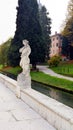 Statue, river, tree and street in Castelfranco Veneto, in Italy