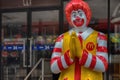 A statue of Ronald McDonald in front of a fast food restaurant