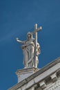 Statue of Saint with cross at San Stae catholic Church in Venice