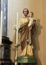 Statue of Saint Joseph holding the Child Jesus in the Church of Saint George in Varenna, Italy.