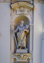 Statue of Saint Paul holding a sword and a book on the facade of the Basilica of Saint Margaret of Antiochia