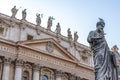 Statue of Saint Peter and Saint Peter`s Basilica at background in St. Peter`s Square, Vatican City, Rome Royalty Free Stock Photo