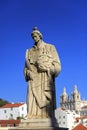 Statue of Saint Vicente de Fora in Lisbon and house roofs