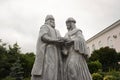 Statue of Saints Peter and Fevronia of Murom with cloudy sky and park on background in Skopin of Ryazan oblast, Russia.