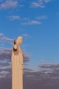 Statue sculpture of Jesus Christ the Savior. Background of blue sky and white clouds. Royalty Free Stock Photo