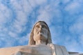 Statue sculpture of Jesus Christ the Savior. Background of blue sky and white clouds. Royalty Free Stock Photo