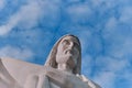 Statue sculpture of Jesus Christ the Savior. Background of blue sky and white clouds. Royalty Free Stock Photo