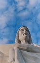 Statue sculpture of Jesus Christ the Savior. Background of blue sky and white clouds. Royalty Free Stock Photo