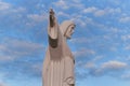 Statue sculpture of Jesus Christ the Savior. Background of blue sky and white clouds. Royalty Free Stock Photo