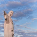 Statue sculpture of Jesus Christ the Savior. Background of blue sky and white clouds. Royalty Free Stock Photo