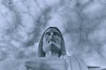 Statue sculpture of Jesus Christ the Savior. Background of gray sky and white clouds. Black and white photo. Royalty Free Stock Photo