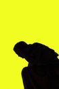Statue shadow silhouette of an angel against a yellow background