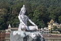 Statue of Shiva, Hindu idol near Ganges River water, Rishikesh, India. The first Hindu God Shiva. Sacred places for pilgrims Royalty Free Stock Photo