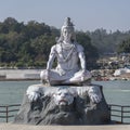 Statue of Shiva, Hindu idol near Ganges River water, Rishikesh, India. The first Hindu God Shiva. Sacred places for pilgrims Royalty Free Stock Photo