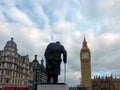 The statue of Sir Winston Churchill faces the Elizabeth Tower and Houses of Parliament in Westminster, London Royalty Free Stock Photo