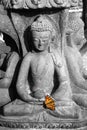 Statue of a sitting deity with butterfly