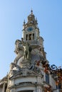 Statue of a slave breaking free from chains while holding a flag. Old building in Aliados avenue, Porto