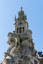 Statue of a slave breaking free from chains while holding a flag. Old building in Aliados avenue, Porto