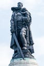 Statue of a Soviet soldier with a sword holding a German child at Treptower Park.