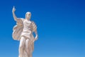 A statue of St Elijah the prophet holding a knife on a blue sky Royalty Free Stock Photo