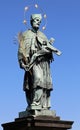 statue of Saint John o who holds the crucifix in his hands