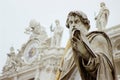 The statue of St. Paul in front of the facade of St. Peter`s basilica Royalty Free Stock Photo