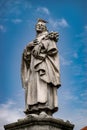 Statue of St. Philip on Charles Bridge in Prague with a dove on its head