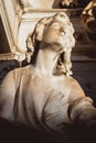 Statue of angel at cemetery. stoned angel praying in an old cemetery. Graveyard old crying angel sculpture on funeral. Death, loss Royalty Free Stock Photo