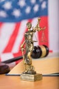 Statue of Themis and judge's gavel on a table. Royalty Free Stock Photo