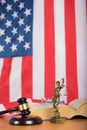 Statue of Themis and judge's gavel on a table. Royalty Free Stock Photo