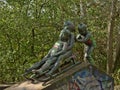 Statue of three kids playing with a sledge