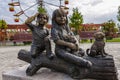 Statue of a two children near little doggy