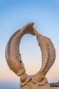 Statue of two fishes on a Muttrah corniche with a fortress on background, Muscat, Oman....IMAGE