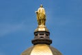 Notre Dame - Circa August 2018: Statue of Mary atop the Golden Dome of the University of Notre Dame Main Administration Building